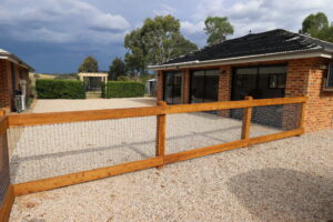 Two rail face-fixed post and rail timber fence