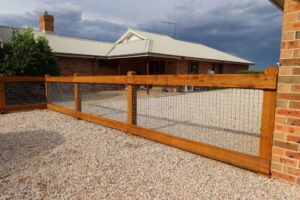 Two rail face-fixed post and rail timber fence