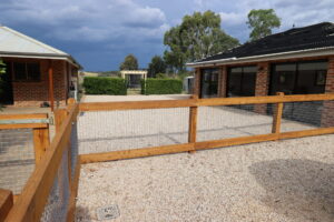 Two rail face-fixed post and rail timber fence