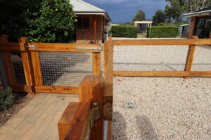 Two rail face-fixed post and rail timber fence