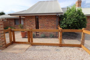 Two rail face-fixed post and rail timber fence