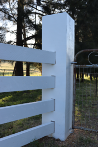 photo of four rail timber post and rail fence with 200mm x 200mm end posts. Finished in White Weathershield.